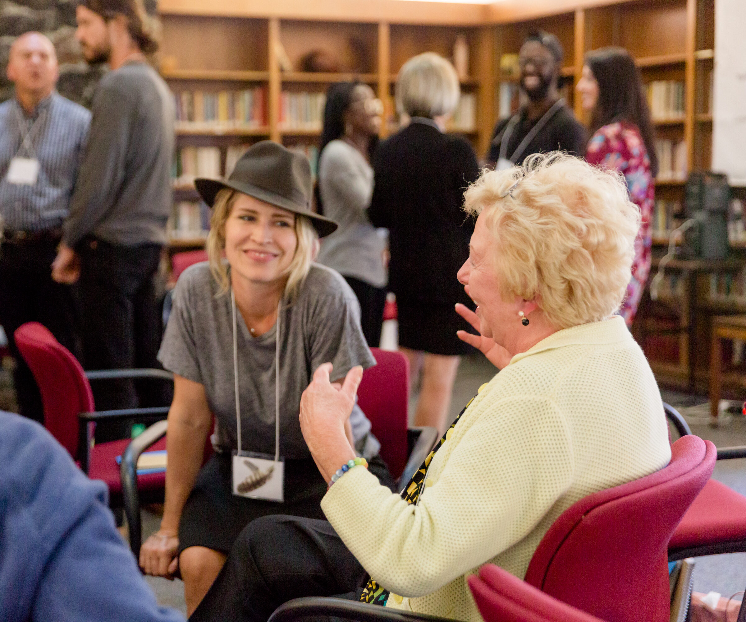 Two people discuss the growth process of the Enneagram at a training