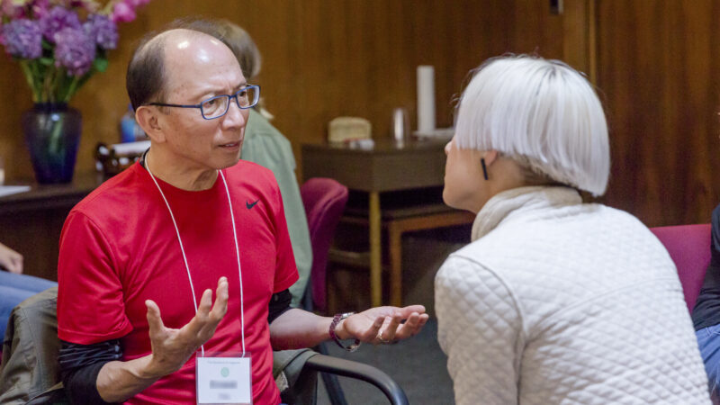 Two students complete an exercise in an Enneagram training