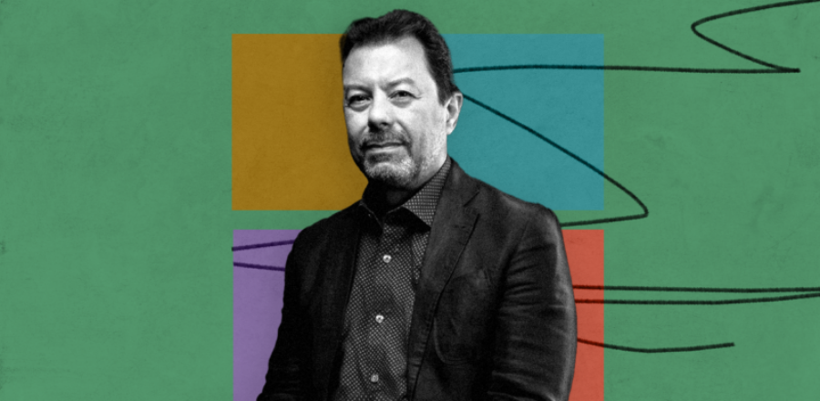 black and white photo of man on green background with 4 colored blocks and pencil scribble