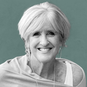 A black and white photo of Leslie Herschberger on a grey-teal background