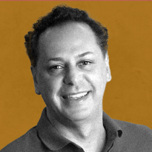 A black and white photo of Patrick Kayrooz on an burnt orange background